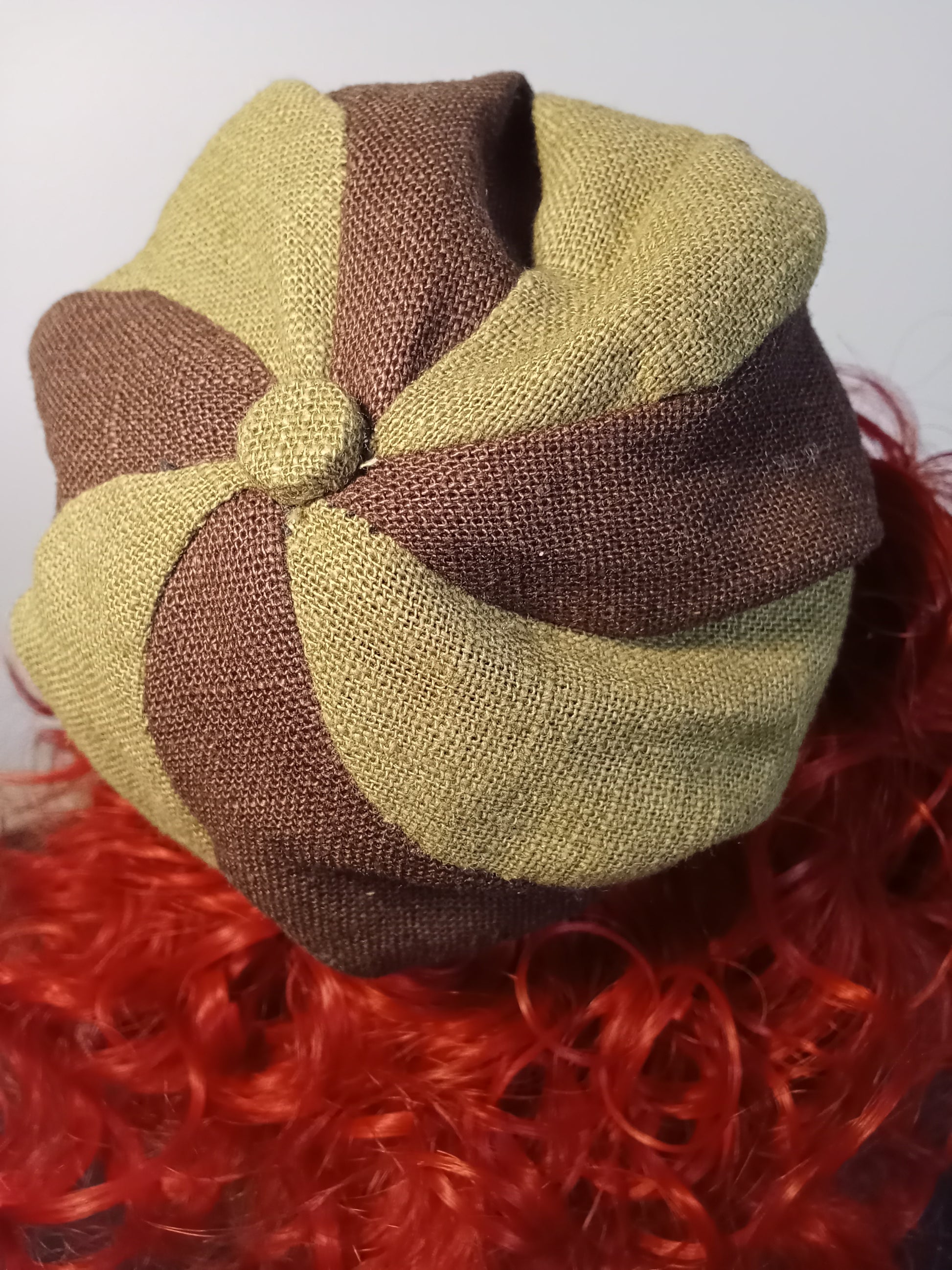 “Back view of Handmade collectible doll with red curly hair wearing a colorful boho outfit.”